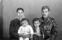 Studio portrait of a member of the Palestinian resistance with his family