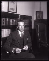David H. Clark seated in an office, Los Angeles, 1931