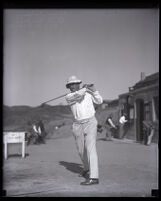 Golfer A. S. Rendell swings his club at the Annandale Country Club, Pasadena, 1917-1925