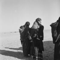 Bedouin women carrying their child