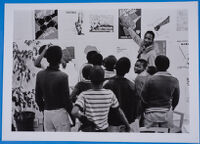 Thami Mnyele showing poster exhibition at the Swedish Embassy, Gaborone, Botswana, 1981