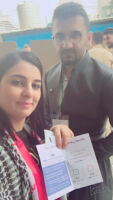 Voting in Erbil, an Arab woman holding a ballot, and a young man wearing Kurdish clothing