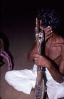 Sarpam Thullal Pulluvan Serpent Ritual - O. K. Raman holding a Pulluvan vīṇā kunju, Peramangalam (India), 1984