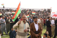 Two men wearing Kurdish clothes
