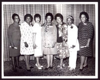 Past western regional directors of Delta Sigma Theta Sorority at a banquet event with Miriam Matthews and 6 others, Los Angeles, 1972