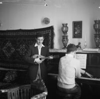 Indoor snapshot of two young men playing music