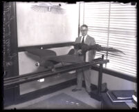 Wayland Avery compares J. H. Montgomery's model airplane designed like bird's wings and a model of a vulture, Los Angeles, 1930