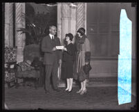 Ned R. Powley of the Southern California Telephone Company hands a donation check to Mrs. Walter Hubner and Mrs. Edmund Jackson of the Community Chest, Los Angeles, 1927