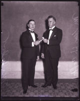 Realtors George H. Coffin Jr. and Harry M. Culver holding a gavel, Los Angeles, 1926