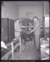 W. W. Ashe and detective Chester A. Lloyd uncover a counterfeiting plant, Los Angeles, 1929
