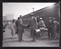 Arthur S. Bent shakes hands with Charles C. Teague at a train station, Los Angeles,  1920-1939