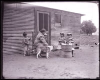 Family doing laundry outside of their home, San Gabriel, 1920s