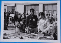 Rhona Mnyele and Teresa Devant outside Main Hall of the University of Botswana selling posters and publications, 1982