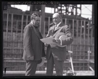 G. C. Ward and Russell H. Ballard of Southern California Edison Company review documents on a job site, Los Angeles, 1920-1930