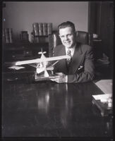 Judge Samuel R. Blake with a model propeller airplane, Los Angeles, circa 1920s