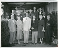Dr. John A. Somerville at a gathering with 13 other men and women, 1950s
