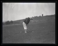 Professional golfer Harry Pressler putts at a golf course, Los Angeles County, 1922-1940