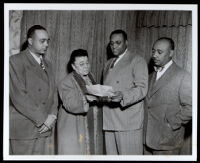 Charlotta Bass and 3 men look at a letter, 1940-1960