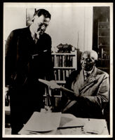 Ralph Bunche with an unidentified man in an office, 1960-1965