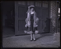 Doris Braly standing in front of a wide open door, Los Angeles, circa 1920-1927