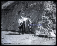 Three engineers or geologists examine a rock face after the collapse of the Francis Dam, San Francisquito Canyon (Calif.), 1928