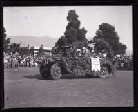 Carrie Jacobs Bond  and others riding in a decorated automobile at the Tournament of Roses parade, Pasadena, 1927