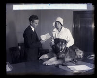 Film actress Fritzi Ridgeway and her dog, Volk, being warned by Deputy Prosecutor William P. Carr at City Hall, Los Angeles, 1930