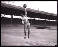 Baseball player Les Cook catching a ball in mid-air at Washington Park, Los Angeles, circa 1925