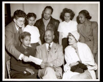 Dr. John Somerville with seven unidentified people, 1950s