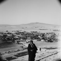 Bedouin man in front of a watering station