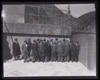 Group of men wearing suits and hats standing by the Pacoima Dam, Los Angeles County, circa 1928