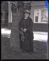 Augusta Richardson, spouse of Governor Friend W. Richardson, smiles in front of a tree while on vacation, Long Beach, 1923