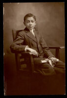 Young man wearing a suit and holding a diploma, 1890-1920
