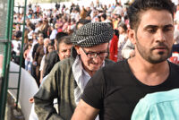 Men walking to the Referendum rally in Sulaimani Stadium