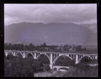 Colorado Street Bridge with San Gabriel mountains in background, Pasadena, 1920s