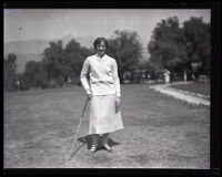 Golfer Dorothy Richards stands with a club in her hand at the Flintridge Country Club, La Cañada, 1925