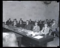 Convicted murderer Russell Beitzel seated, center, at the defendant's table with four attorneys during his trial, Los Angeles, 1928
