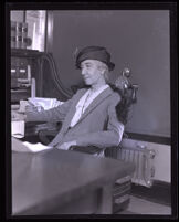 Attorney Elizabeth L. Kenney sitting at her desk, Los Angeles, 1920-1939