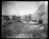 Workers using a tractor to clear debris after the flood resulting from the failure of the Saint Francis Dam, Santa Clara River Valley (Calif), 1928