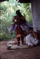 Ottan Thullal - a dresser finishes the costume of Ottan Thullal dancer B. C. Balachandar, for his performance of Kalyana Sougandhikam, Ayamkudy (India), 1984