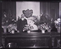 Judge Benjamin Franklin Bledsoe next to flower arrangements, Los Angeles, circa 1920s