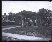 Group of people gathered at the front porch of a home, Belvedere Heights (Los Angeles), 1931