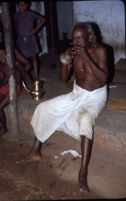 Kunyāttu Kārnavar playing a kuzhal, a double-reed wind instrument, Pengamuck (India), 1984