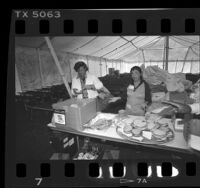 Volunteers making sandwiches for occupants of Tent City II, in Los Angeles, Calif., 1986