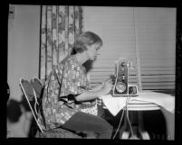Actress Joanne Woodward using sewing machine, 1958