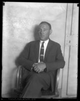 Harry Alpine, bootlegger and gambler sitting in chair in jail after being charged in shooting