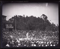 View of boxing match at Wilmington Arena with huge crowd surrounding ring in Los Angeles, circa 1925