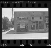 Storefront of Larchmont Village Cleaners with epitaph sign reading "R.I.P...Cause of Death Polyester" posted over door in Los Angeles, Calif., 1972