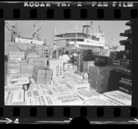 Boxes of clothing and food for Nicaragua earthquake victims being loaded onto freighter in Long Beach, Calif., 1973