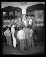 George Bailey talking with group of boys at All Nations Boys Club in Los Angeles, Calif., 1948